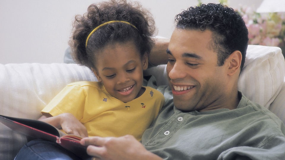 A father and daughter reading
